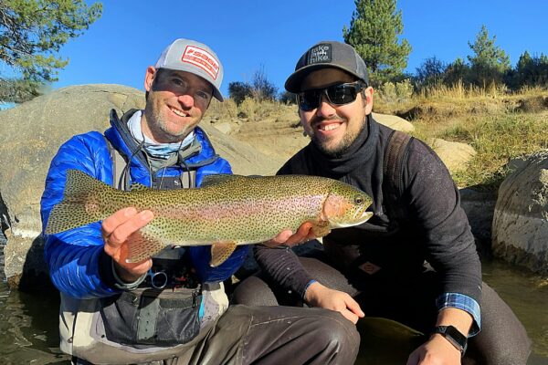 A happy guest with his first rainbow trout on the Truckee River in lake tahoe