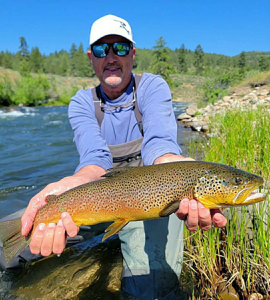 Fly fishing the Truckee River during summer at in the riffles, showing ideal conditions for trout fishing in June, July, and August.